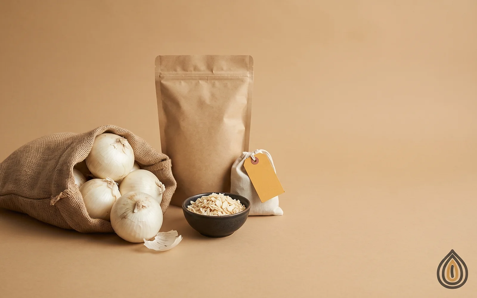 Fresh white onions spilling from a jute sack beside a kraft sack and a bowl of dehydrated onion flakes on a plain backdrop
