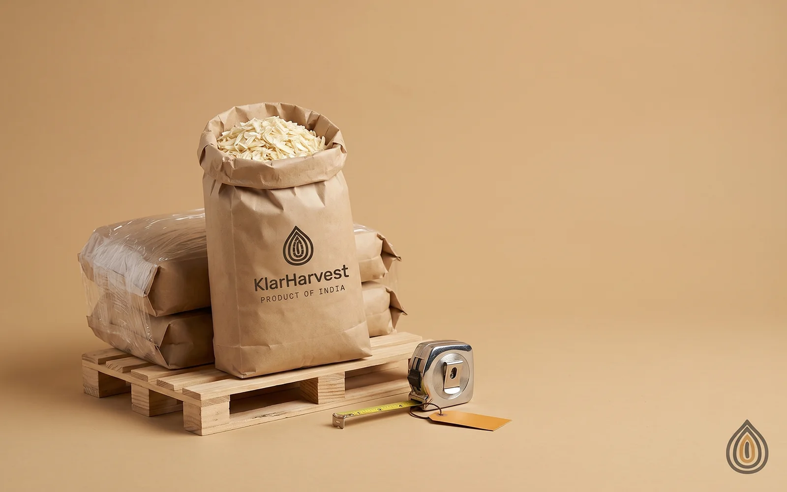 A single small pallet of three kraft sacks of dehydrated onion standing alone on a wide plain backdrop