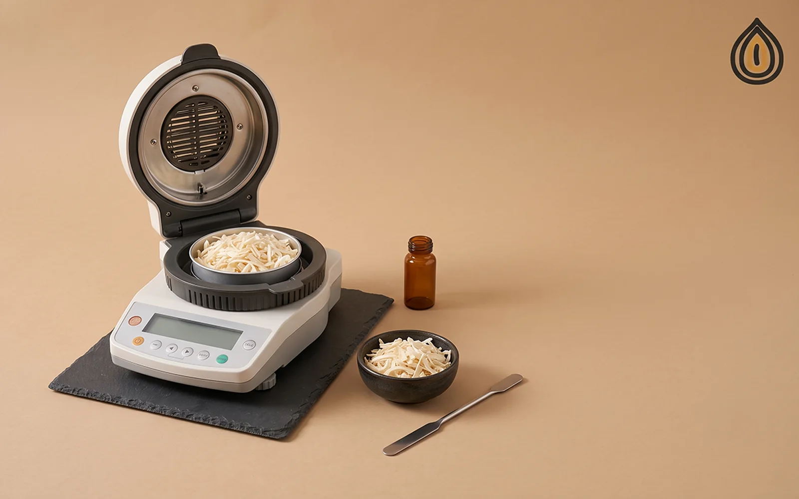 Halogen moisture analyser with a sample pan of dehydrated onion flakes on a laboratory bench