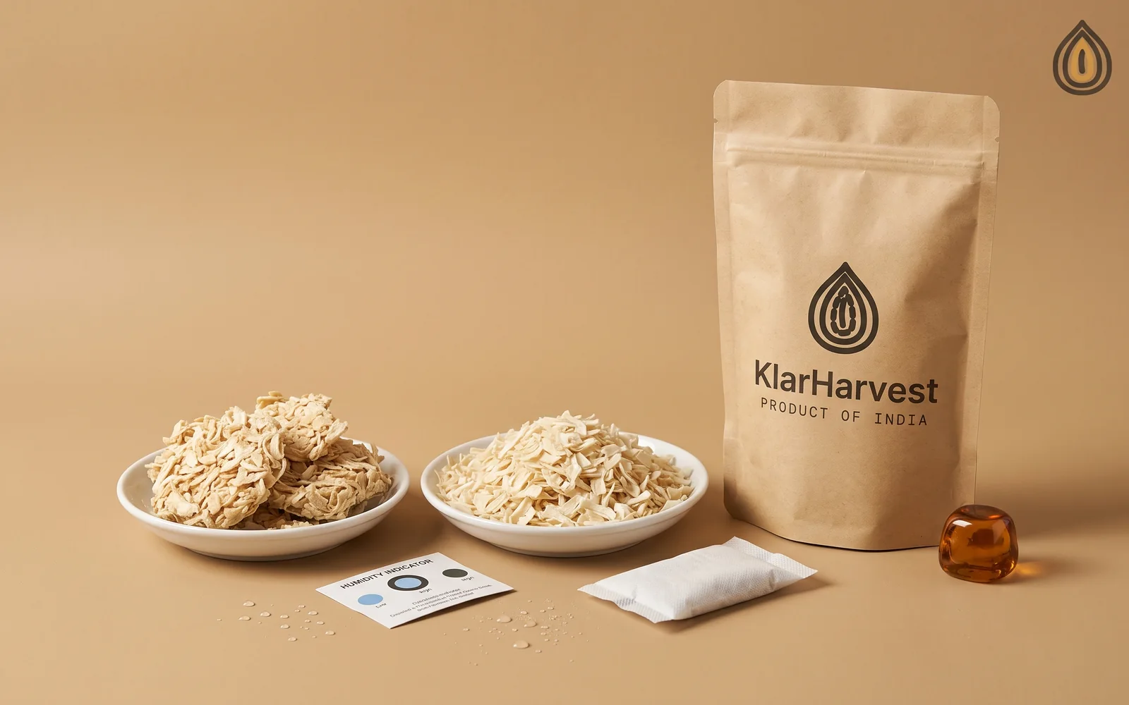 Loose onion flakes beside caked flakes, a humidity card, a desiccant sachet and a kraft sack on a plain backdrop